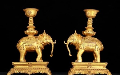 A pair of huge gilt bronze hieroglyphic candlesticks