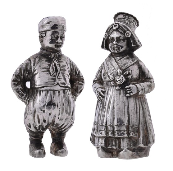 A pair of silver pepperettes modelled as a boy and girl
