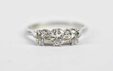 A platinum and diamond three stone graduated ring, the claw...