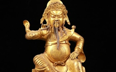 A serene gilt bronze statue of Guan Gong
