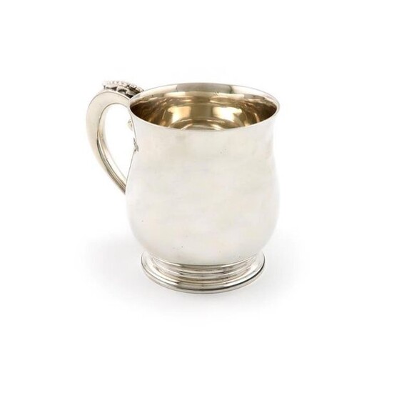 A silver mug, by F.T Ray and Co, London 1936, baluster form, the scroll handle with cut-card and beaded decoration, on a circular foot, height 11cm, approx. weight 13.5oz.