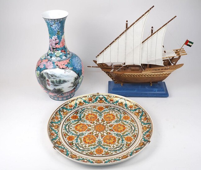 A wooden handmade sailing boat with material sails on a blue resin mount, with brass decoration, in original presentation box, 56cm wide, 48cm high, together with a Chinese Shanshui porcelain vase decorated in underglaze with claborate design, in...