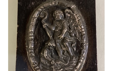 An 18th Century silver plaque embossed with cherub decoratio...