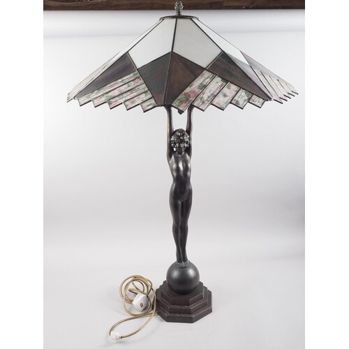 An Art Deco design bronzed table lamp, formed as a girl hold...