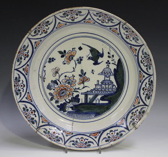 An English Delft charger, Bristol, 18th century, painted in blue, green and red with a chinoiserie p