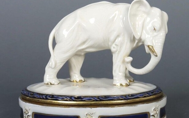 Art deco lidded box with elephant Bohemia, Duchcov, Duxer porcelain factory, after 1910, light-coloured body with cream glaze, oval box with floral relief decoration, the lid also with relief border and naturalistic, fully plastic elephant bull, box...