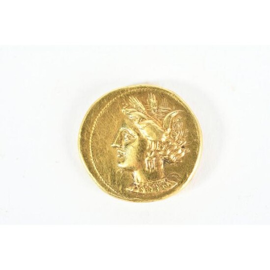 GOLDEN CURRENCY IN THE TASTE OF ANTIQUE with a woman's profile on one side and a horse's head on the other. Weight 9grs.