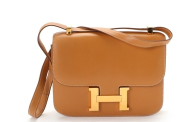 NOT SOLD. Hermès: A "Constance" bag made of brown leather with gold toned hardware, a...
