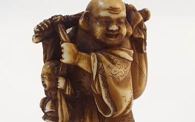 Netsuke, Hotei standing with a stick on his shoulders holding a large sack and karako - Ivory - Tomochika - Japan - Meiji period (1868-1912)
