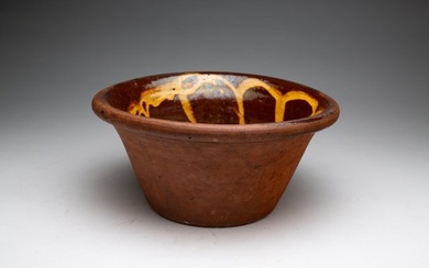 REDWARE BOWL WITH SLIP DECORATION.