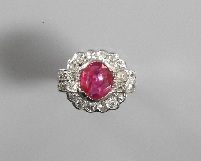 White gold ring, 750 MM, centered on an oval ruby weighing 1.87 carat certified "without thermal modification, Burmese origin" by the CGL Laboratory between two bars and a row of diamonds, size: 49, weight: 5.9gr. rough.